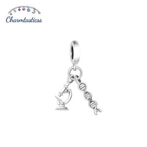 May include: A silver-toned charm featuring two dangling pendants attached to a circular bail. One pendant is shaped like a scientific microscope, and the other pendant is shaped like a double helix DNA strand. The Charmtasticss logo is visible.