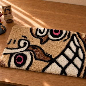 May include: A rectangular tufted rug featuring a stylised graphic design of a face with large eyes, pink pupils, and a wide grin. The rug is crafted with tan, white, black, and brown yarn, showcasing a textured, looped pile surface throughout.