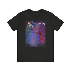 Könnte beinhalten: Ein schwarzes Kurzarm-T-Shirt mit einem Grafikdruck eines roten Drachen in einem blauen Overall. Über dem Drachen befinden sich eine Discokugel und der Text "Disco and Dancing" in einer stilisierten Schriftart auf violettem Grund.