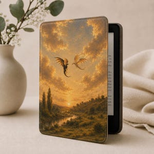 May include: A protective e-reader case featuring a printed landscape illustration of two dragons flying in a golden sunset sky above a river and rolling hills. The case has a textured finish and is attached to a black electronic reading device.