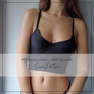 May include: A black corset-style top with thin shoulder straps and a structured bodice. The text on the image reads: PDF sewing pattern | JADE top-corset SixaPattern. The garment features a cropped length and a fitted silhouette.