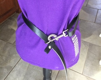 May include: Purple t-shirt with the text "Crazy Dog Lady" printed on the front. A black leather belt with a silver buckle is worn around the waist.