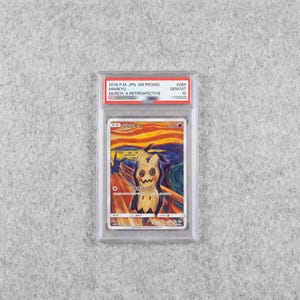 May include: A graded Mimikyu trading card in a clear plastic slab. The card features a Mimikyu character in a style inspired by The Scream painting, with orange, yellow, and blue swirls. The label reads 2018 P.M. JPN. SM PROMO MIMIKYU MUNCH: A RETROSPECTIVE GEM MT 10.