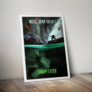 Puede incluir: Un póster enmarcado con una ilustración dividida de Metal Gear Solid 3 Snake Eater. La parte superior muestra un paisaje rocoso oscuro con mariposas naranjas, mientras que la inferior muestra una figura nadando bajo el agua junto a un pez.