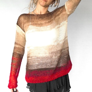 May include: A knitted sweater with a gradient design, transitioning from brown to white and red. The long-sleeved sweater is paired with a black skirt and lace leggings. The sleeves and bottom hem are red.
