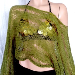 May include: A green crochet top with a loose, open-weave design. The top has a wide, off-the-shoulder neckline and a cropped length.