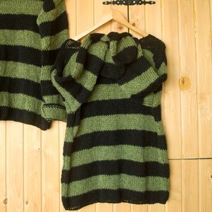 Soft mohair-blend striped sweater in forest green and black, featuring a boxy cut and relaxed silhouette for fall and winter styling.
