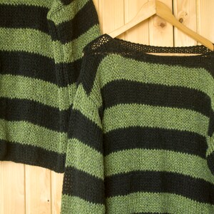 Cozy mohair sweater with thick black and green stripes, hand-knit for a soft feel and breathable design—perfect for layering in colder seasons.