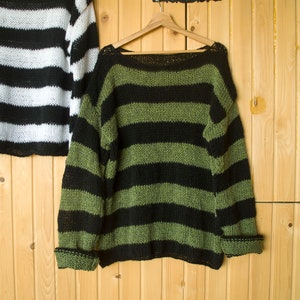 Striped grunge sweater in black and muted green tones, hand-knit with airy texture for unisex wearers who love edgy, laid-back styles.