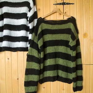 Black and green horizontal striped sweater, oversized fit with dropped shoulders, made for punk, goth, or alternative outfit layering.