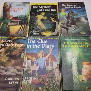 May include: A collection of vintage Nancy Drew mystery books. The covers feature colorful illustrations of scenes from the stories, with titles like "The Bungalow Mystery" and "The Clue in the Diary."