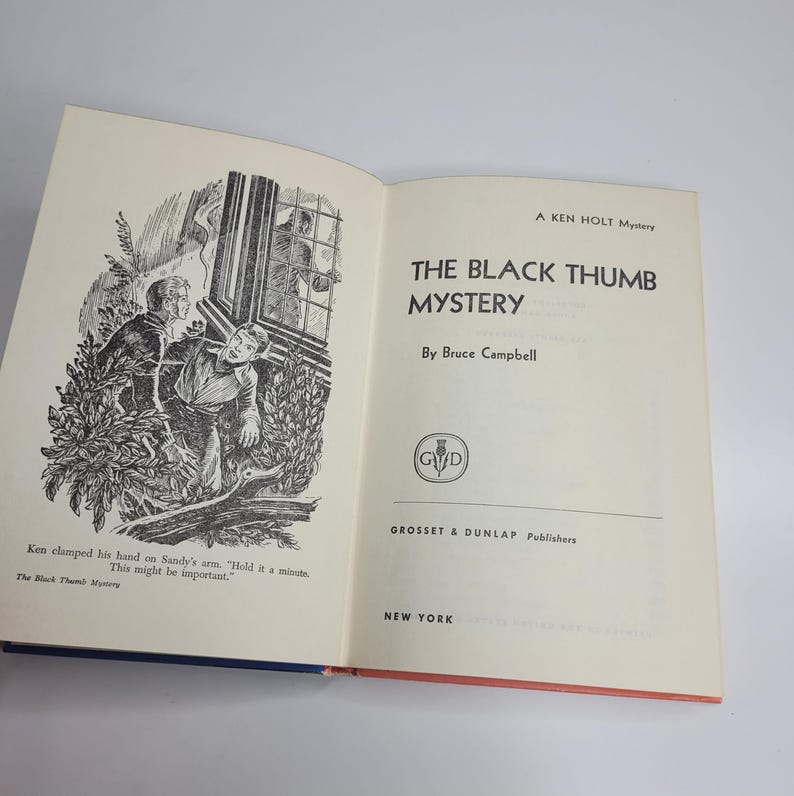 May include: Open book titled "THE BLACK THUMB MYSTERY" by Bruce Campbell. The cover is off-white with black text and a black and white illustration of two men. Published by Grosset & Dunlap, New York.