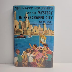May include: A vintage book cover titled "The Happy Hollisters and the Mystery in Skyscraper City" by Jerry West. The cover features an illustration of children on a boat with a city skyline in the background.