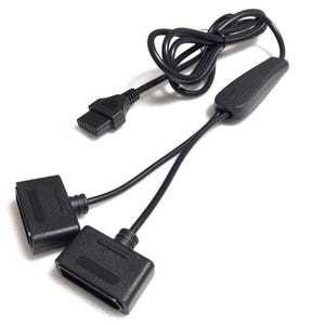 May include: A black video game controller splitter cable featuring one male connector and two female ports. The cable includes a central plastic housing unit and a coiled black cord, designed to allow two controllers to connect to a single console port.