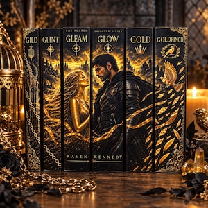 May include: A set of six books from The Plated Prisoner Series by Raven Kennedy, featuring black spines with gold foil illustrations of a couple, a bird, and a crown. The titles Gild, Glint, Gleam, Glow, Gold, and Goldfinch are printed in gold.