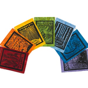 May include: A set of seven colorful fabric flags with inspirational messages printed on them. The flags are arranged in a rainbow pattern, with each flag featuring a different color and message. The messages include "be bold and engaged", "be inclusive and kind", "be compassionate and grateful", "be collective and hopeful", "be the best patient", "be imperfect and gracious", and "seek connections and be kind".