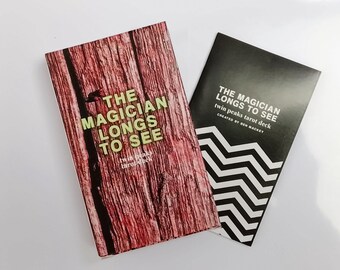 May include: A Twin Peaks tarot deck set featuring two rectangular items. One item has a red wood grain pattern with the text THE MAGICIAN LONGS TO SEE. The second item is black with white chevron patterns and the text THE MAGICIAN LONGS TO SEE.