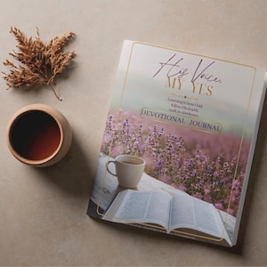 May include: A devotional journal titled His Voice, My Yes with a cover featuring a lavender field, a white coffee mug, and an open book. The text reads Learning to hear God, follow His lead & walk in obedience. A small cup of tea and dried foliage.