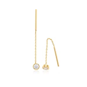 May include: A pair of gold threader earrings, each featuring a delicate gold chain suspended from a straight post. One end of each chain is anchored by a single, round, clear, brilliant-cut gemstone set in a polished gold bezel setting.