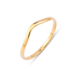May include: A polished yellow gold ring featuring a smooth, continuous band with a distinct V-shaped chevron curve at the top. The metal surface is reflective and uniform in color, showcasing a simple, curved silhouette without any stones or engravings.