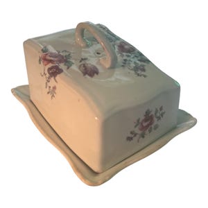 A vintage floral transferware ceramic serving dish with a handle. No branding. Stains on inside from use.