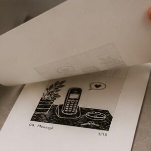 Puede incluir: Una impresi&oacute;n en lin&oacute;leo en blanco y negro sobre papel blanco que muestra un tel&eacute;fono inal&aacute;mbrico en su base, una planta en maceta, un cuenco peque&ntilde;o y un globo de texto con un coraz&oacute;n. La impresi&oacute;n dice 04. Mensaje y est&aacute; numerada 1/15.