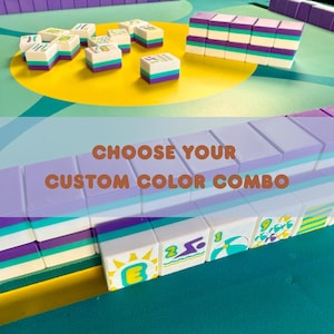 May include: A collection of colorful Mahjong tiles in various arrangements. The tiles feature white, purple, teal, and green accents. The image includes the text "CHOOSE YOUR CUSTOM COLOR COMBO".