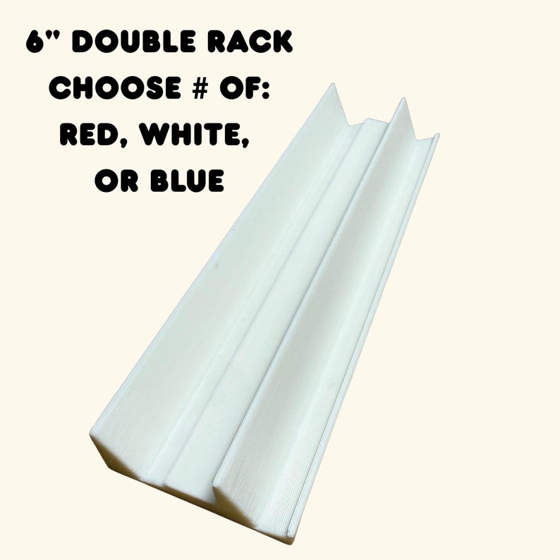 May include: A white 6-inch double rack with two parallel channels. The text above the rack reads: 6" DOUBLE RACK CHOOSE # OF: RED, WHITE, OR BLUE. The rack features a smooth, elongated design with a central divider and two side walls.