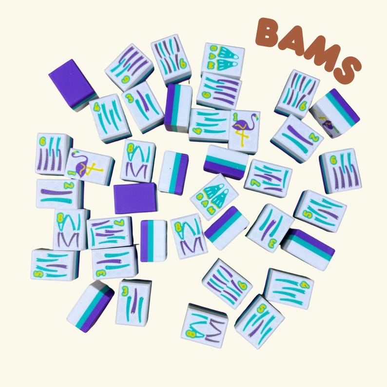 May include: A collection of white Mahjong tiles with teal, purple, and green accents. Some tiles feature the text "BAMS" and various symbols, including a flamingo and the number 3. The tiles are scattered on a light beige background.
