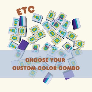 May include: A collection of white, rectangular tiles with various designs and text, including "SPF", "JOKER", and letters. Some tiles feature a sun, a drink, and a flower. The text "CHOOSE YOUR CUSTOM COLOR COMBO" is also present.