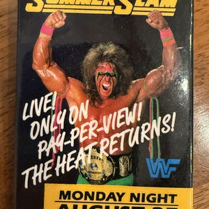 May include: A rectangular magnet featuring The Ultimate Warrior with face paint, arm tassels, and a championship belt. Text reads: SUMMERSLAM, LIVE! ONLY ON PAY-PER-VIEW! THE HEAT RETURNS!, WWF logo, and MONDAY NIGHT AUGUST 27 on a yellow background.
