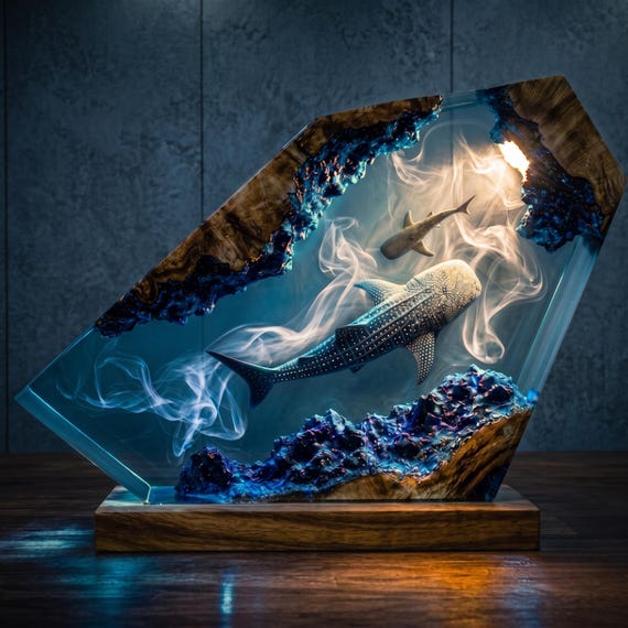 A custom ocean-themed epoxy resin lamp with a whale shark suspended in glowing amber wood — genuinely one-of-a-kind and personalizable for a specific person.