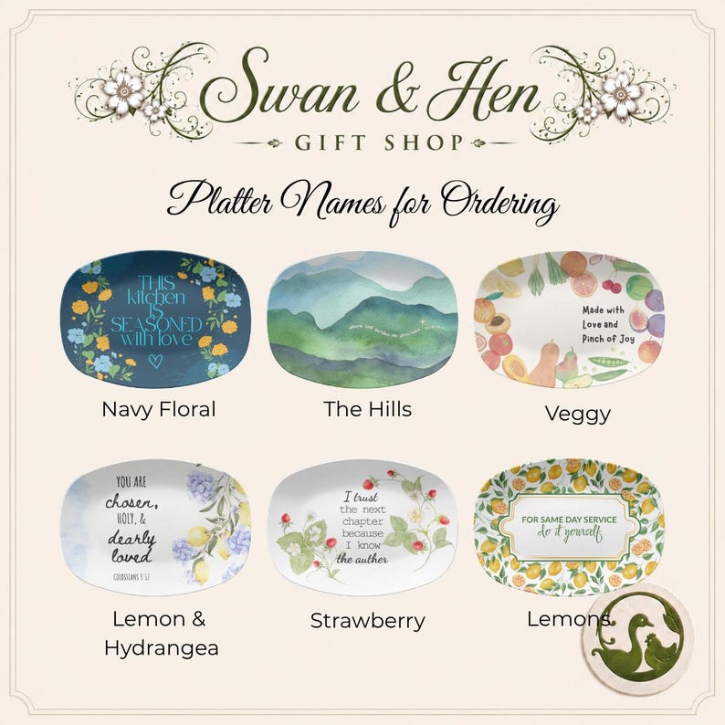 May include: A collection of six oval platters from Swan & Hen Gift Shop, each featuring unique designs: Navy Floral with text, The Hills landscape, Veggy with fruit and text, Lemon & Hydrangea with text, Strawberry with text, and Lemons with text.