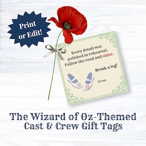 May include: A square gift tag featuring a red poppy with a silver ribbon, green decorative borders, and text reading: Every detail was polished in rehearsal. Follow the road and shine. Break a leg! From: with an illustration of two light blue shoes.