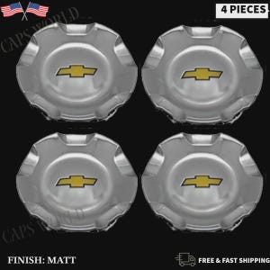May include: A set of four circular chrome wheel center caps, each featuring a gold Chevrolet bowtie emblem in the center. The caps have a scalloped edge design and a reflective metallic finish. The text 4 PIECES is visible in the top right corner.