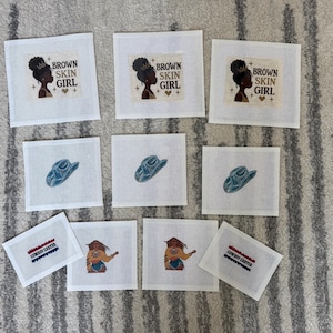 May include: A collection of ten square fabric patches featuring printed designs. Three patches show a profile of a person with the text "BROWN SKIN GIRL". Three patches display a blue cowboy hat. Two patches show a person in a yellow shirt, and two patches feature the text "COWBOY CARTER" in blue and red.