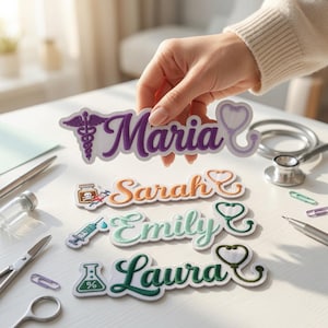May include: Four custom embroidered name patches with medical-themed icons and stethoscopes. The top patch is purple with the name Maria and a caduceus. Below are orange, light green, and dark green patches with names Sarah, Emily, and Laura.