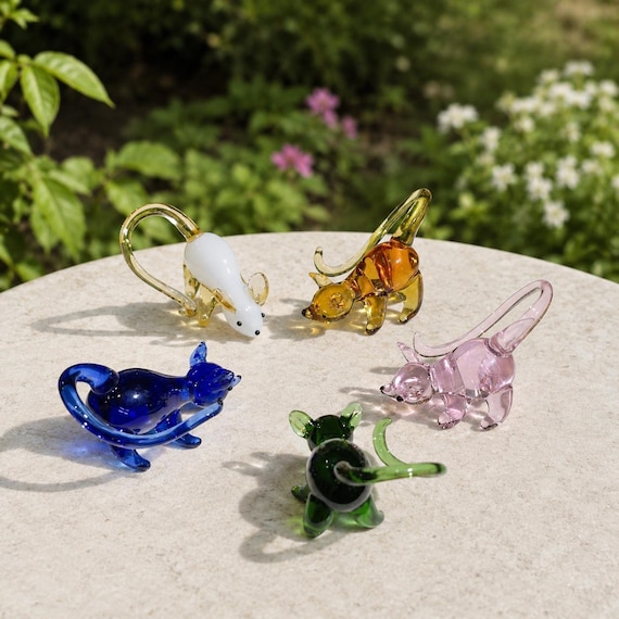 Tiny flameworked glass mouse with vivid color detail — the kind of miniature sculpture that earns a permanent spot on a windowsill and a 'where did you get that?'