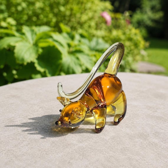 Tiny flameworked glass mouse with vivid color detail — the kind of miniature sculpture that earns a permanent spot on a windowsill and a 'where did you get that?'