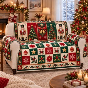 May include: A quilted sofa cover featuring a festive Christmas pattern with nutcrackers, decorated pine trees, golden bells, poinsettias, snowflakes, and candy canes in a red, green, and cream checkered design with a holly leaf border.