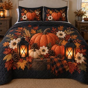 May include: A black quilted bedspread and two matching pillow shams featuring a printed design of orange pumpkins, white sunflowers, pinecones, autumn leaves, and two black lanterns with glowing candles, arranged on a wooden crate surface.