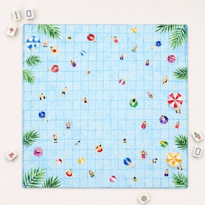 May include: A square game mat featuring a light blue swimming pool grid pattern with illustrations of people swimming, colorful pool floats, beach balls, and umbrellas. Green palm leaves are positioned in the four corners of the mat.