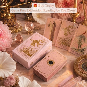 May include: A pink tarot card deck with gold foil accents, including a box labeled The Fool and cards featuring The Fool and The Magician. The text Buy Today Get a Free Divination Reading by Yao Zhou is visible at the top of the image.