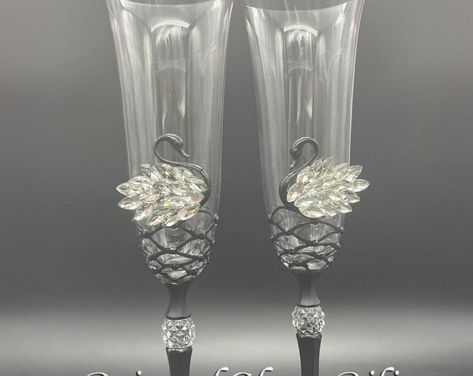 Black white swan toasting champagne flutes