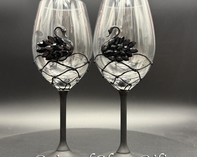 Black swan toasting wine glasses