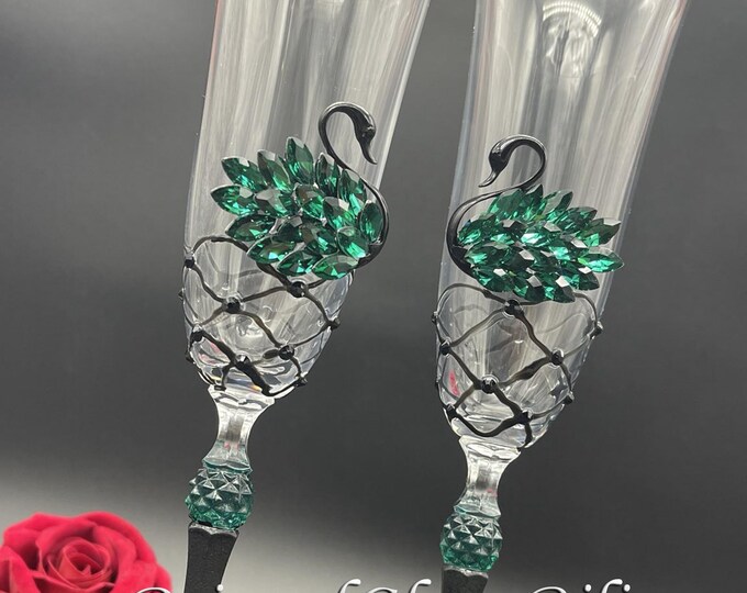 Black green swan toasting champagne flutes