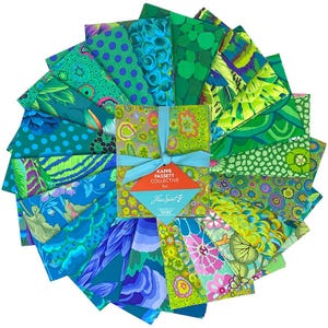 May include: A collection of fabric squares arranged in a circular fan pattern, featuring various shades of green, blue, and teal with diverse floral, geometric, and abstract prints. A central stack is tied with a light blue ribbon and a tag.