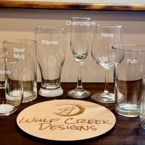 May include: Assortment of clear glass drinking glasses, including a pilsner, beer mug, rocks glass, wine glass, champagne flute, pub glass, and a mason jar mug.