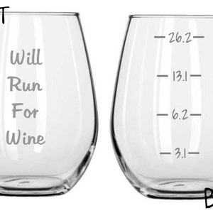 May include: A clear glass wine glass with the text "Will Run For Wine" on the front and markings for 3.1, 6.2, 13.1, and 26.2 miles on the back.