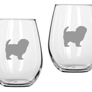 May include: Two clear stemless wine glasses with a gray silhouette of a dog. The dog is standing with its tail curled up. The glasses are empty and have a rounded shape.